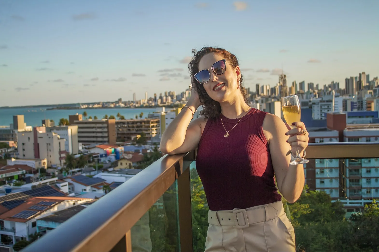 Thais Pavan em uma varanda com vista para o mar